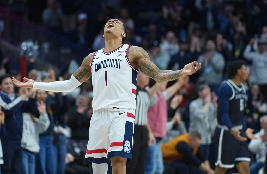 Feb 14, 2026; Storrs, Connecticut, USA; UConn Huskies guard Solo Ball (1) reacts after his three point basket against the Georgetown Hoyas in the second half at Harry A. Gampel Pavilion. Mandatory Credit: David Butler II-Imagn Images