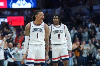 Feb 14, 2026; Storrs, Connecticut, USA; UConn Huskies guard Solo Ball (1) reacts after his three point basket against the Georgetown Hoyas in the second half at Harry A. Gampel Pavilion. Mandatory Credit: David Butler II-Imagn Images