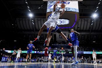 Feb 15, 2026; Indianapolis, Indiana, USA; Butler Bulldogs forward Yohan Traore (21) dunks past Seton Hall Pirates forward Najai Hines (25) during the second half at Hinkle Fieldhouse. Mandatory Credit: Robert Goddin-Imagn Images