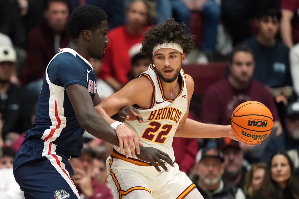 Feb 14, 2026; Santa Clara, California, USA; Santa Clara Broncos forward Allen Graves (22) dribbles against Gonzaga Bulldogs center Ismaila Diagne (left) during the second half at Leavey Center. Mandatory Credit: Darren Yamashita-Imagn Images