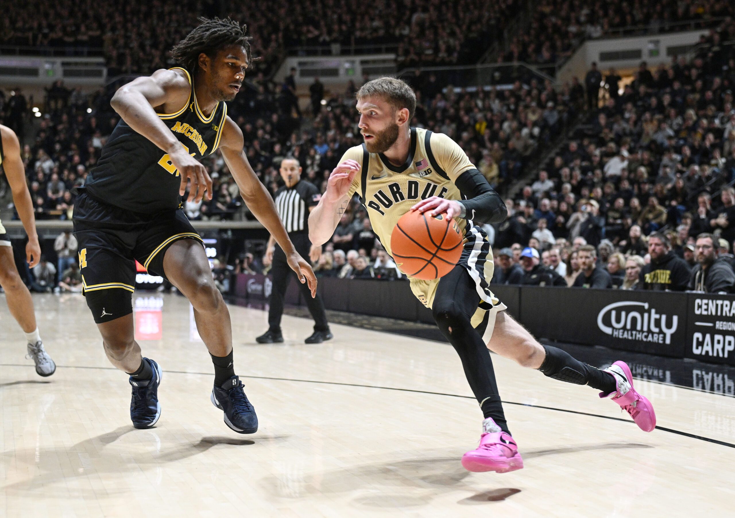 Feb 17, 2026; West Lafayette, Indiana, USA; Purdue Boilermakers guard Braden Smith (3) drives the ball past Michigan Wolverines forward Morez Johnson Jr. (21) during the second half at Mackey Arena. Mandatory Credit: Marc Lebryk-Imagn Images
