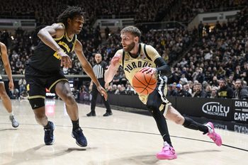 Feb 17, 2026; West Lafayette, Indiana, USA; Purdue Boilermakers guard Braden Smith (3) drives the ball past Michigan Wolverines forward Morez Johnson Jr. (21) during the second half at Mackey Arena. Mandatory Credit: Marc Lebryk-Imagn Images