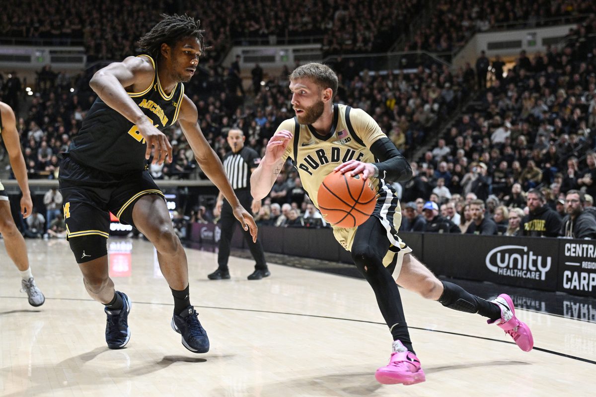 Feb 17, 2026; West Lafayette, Indiana, USA; Purdue Boilermakers guard Braden Smith (3) drives the ball past Michigan Wolverines forward Morez Johnson Jr. (21) during the second half at Mackey Arena. Mandatory Credit: Marc Lebryk-Imagn Images