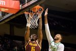Minnesota guard Langston Reynolds, left, dunks under cover from Oregon forward Kwame Evans Jr. as the Oregon Ducks host the Minnesota Golden Gophers on Feb. 17, 2026, at Matthew Knight Arena in Eugene, Oregon.