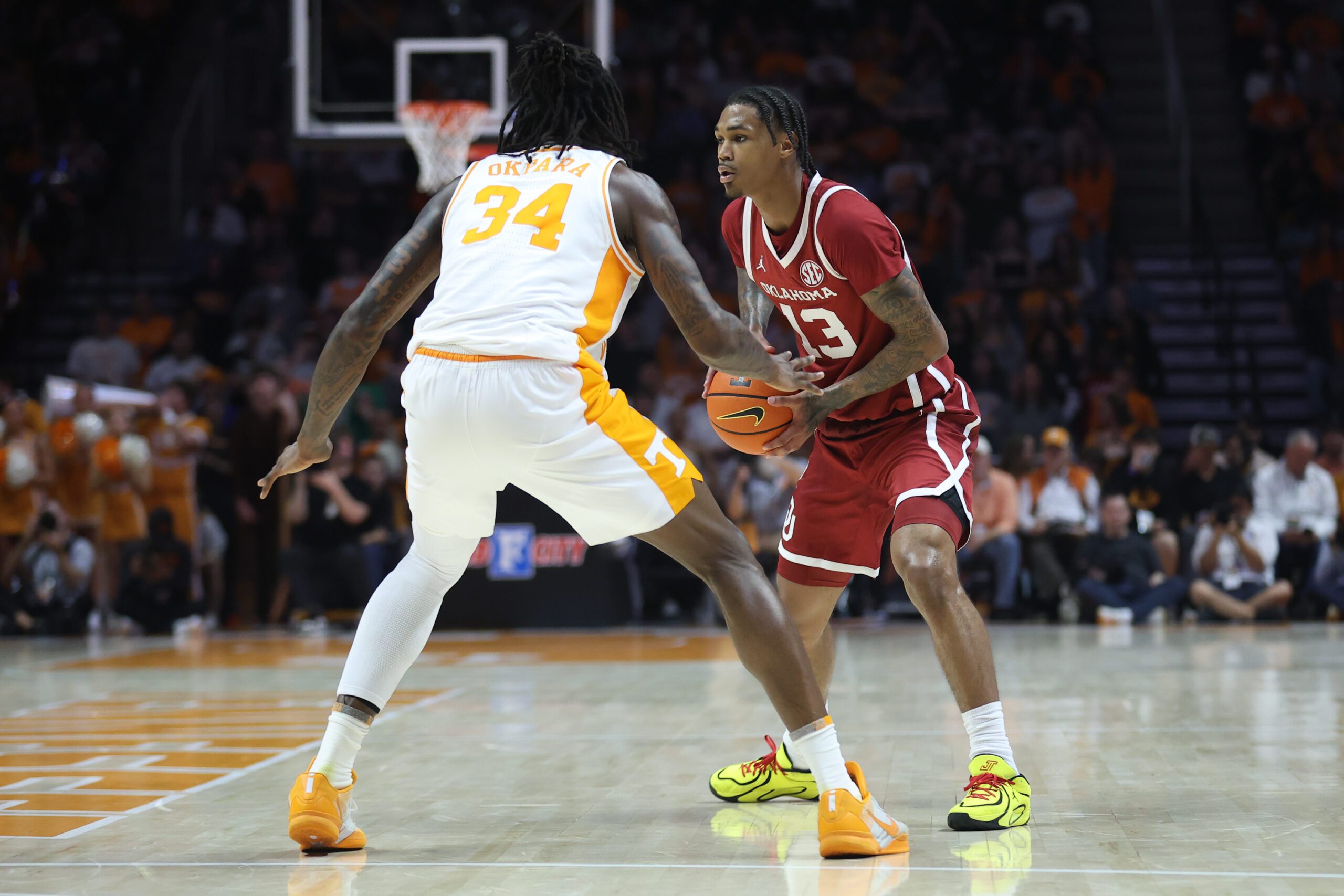 Feb 18, 2026; Knoxville, Tennessee, USA;  Oklahoma Sooners forward Tae Davis (13) moves the ball against Tennessee Volunteers center Felix Okpara (34) during the second half at Thompson-Boling Arena at Food City Center. Mandatory Credit: Randy Sartin-Imagn Images