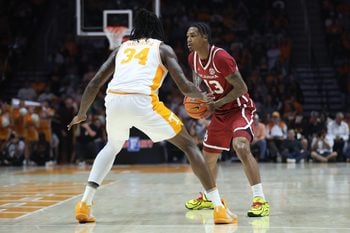 Feb 18, 2026; Knoxville, Tennessee, USA;  Oklahoma Sooners forward Tae Davis (13) moves the ball against Tennessee Volunteers center Felix Okpara (34) during the second half at Thompson-Boling Arena at Food City Center. Mandatory Credit: Randy Sartin-Imagn Images