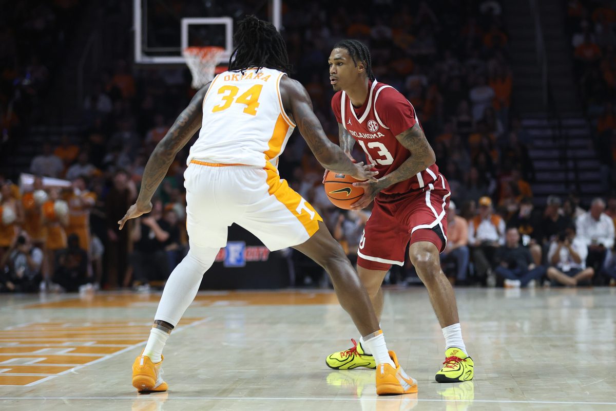 Feb 18, 2026; Knoxville, Tennessee, USA; Oklahoma Sooners forward Tae Davis (13) moves the ball against Tennessee Volunteers center Felix Okpara (34) during the second half at Thompson-Boling Arena at Food City Center. Mandatory Credit: Randy Sartin-Imagn Images