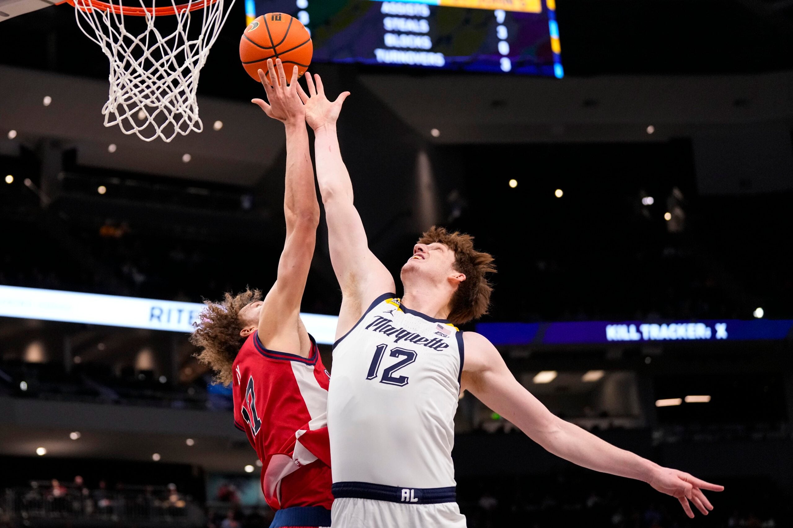 Feb 18, 2026; Milwaukee, Wisconsin, USA;  Marquette Golden Eagles forward Ben Gold (12) and St. John’s Red Storm forward Ruben Prey (17) reach for a rebound during the first half at Fiserv Forum. Mandatory Credit: Jeff Hanisch-Imagn Images