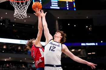 Feb 18, 2026; Milwaukee, Wisconsin, USA;  Marquette Golden Eagles forward Ben Gold (12) and St. John’s Red Storm forward Ruben Prey (17) reach for a rebound during the first half at Fiserv Forum. Mandatory Credit: Jeff Hanisch-Imagn Images