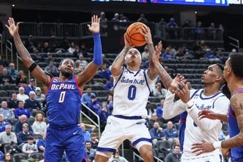 Feb 18, 2026; Newark, New Jersey, USA;  Seton Hall Pirates guard Adam Clark (0) drives past DePaul Blue Demons guard Brandon MacLin (0) in the second half at Prudential Center. Mandatory Credit: Wendell Cruz-Imagn Images