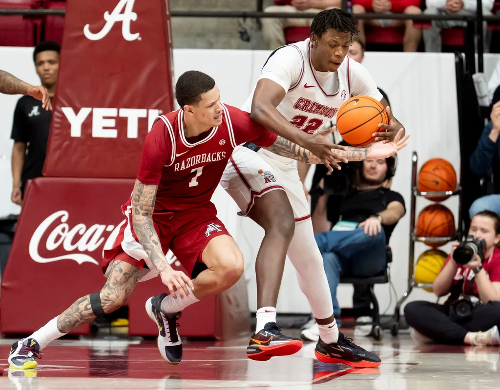 Feb 18, 2026; Tuscaloosa, AL, USA; Arkansas forward Trevon Brazile (7) and Alabama forward Aiden Sherrell (22) fight for a loose ball at Coleman Coliseum. Alabama defeated Arkansas 117-115 in double overtime. Mandatory Credit: Gary Cosby Jr.-Tuscaloosa News