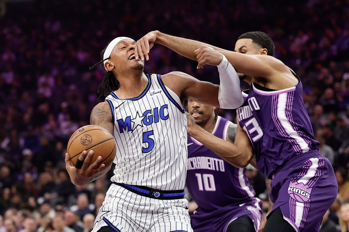 Feb 19, 2026; Sacramento, California, USA; Orlando Magic forward Paolo Banchero (5) drives in against Sacramento Kings forward Keegan Murray (13) during the first quarter at Golden 1 Center. Mandatory Credit: Kelley L Cox-Imagn Images