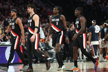 Feb 20, 2026; Portland, Oregon, USA;  Portland Trail Blazers forward Toumani Camara (33), forward Deni Avdija (8), forward Jerami Grant (9) and guard Jrue Holiday (5) walk toward the bench in frustration during the second half against the Denver Nuggets at Moda Center. Mandatory Credit: Jaime Valdez-Imagn Images