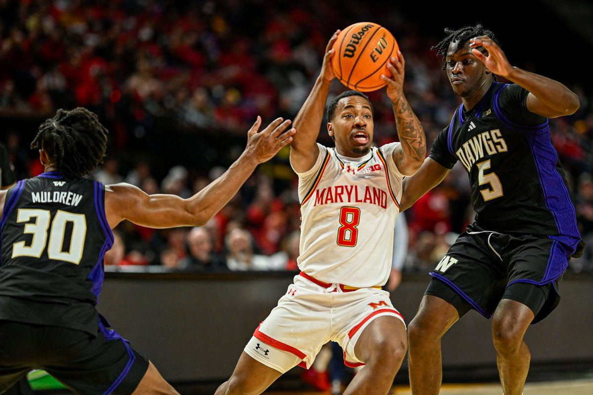 Feb 21, 2026; College Park, Maryland, USA; Maryland Terrapins guard David Coit (8) cuts between Washington Huskies guard Courtland Muldrew (30) and guard Zoom Diallo (5) during the second half at Xfinity Center. Mandatory Credit: Tommy Gilligan-Imagn Images