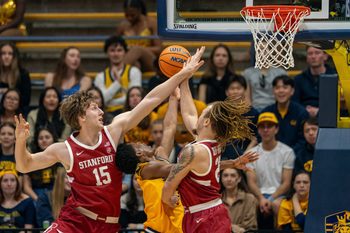 Feb 21, 2026; Berkeley, California, USA;  California Golden Bears guard Dai Dai Ames (7) shoots a layup against Stanford Cardinal forward Oskar Giltay (15) and Stanford Cardinal guard Jeremy Dent-Smith (25) during the first half at Haas Pavilion. Mandatory Credit: Neville E. Guard-Imagn Images