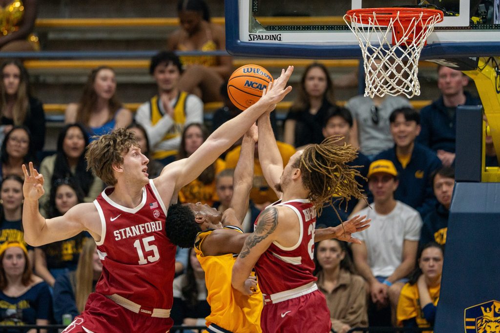 Feb 21, 2026; Berkeley, California, USA; California Golden Bears guard Dai Dai Ames (7) shoots a layup against Stanford Cardinal forward Oskar Giltay (15) and Stanford Cardinal guard Jeremy Dent-Smith (25) during the first half at Haas Pavilion. Mandatory Credit: Neville E. Guard-Imagn Images