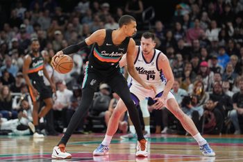 Feb 21, 2026; Austin, Texas, USA;  San Antonio Spurs forward Victor Wembanyama (1) dribbles in front of Sacramento Kings forward Drew Eubanks (19) in the second half at Moody Center. Mandatory Credit: Daniel Dunn-Imagn Images