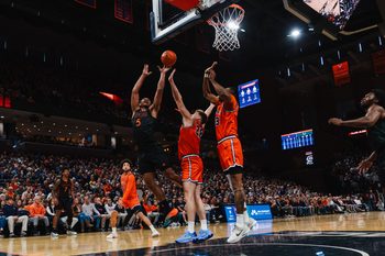 Feb 21, 2026; Charlottesville, Virginia, USA; Miami (FL) Hurricanes forward Malik Reneau (5) shoots the ball while Virginia Cavaliers forward Thijs de Ridder (28) defends during the first half at John Paul Jones Arena. Mandatory Credit: Emily Faith Morgan-Imagn Images