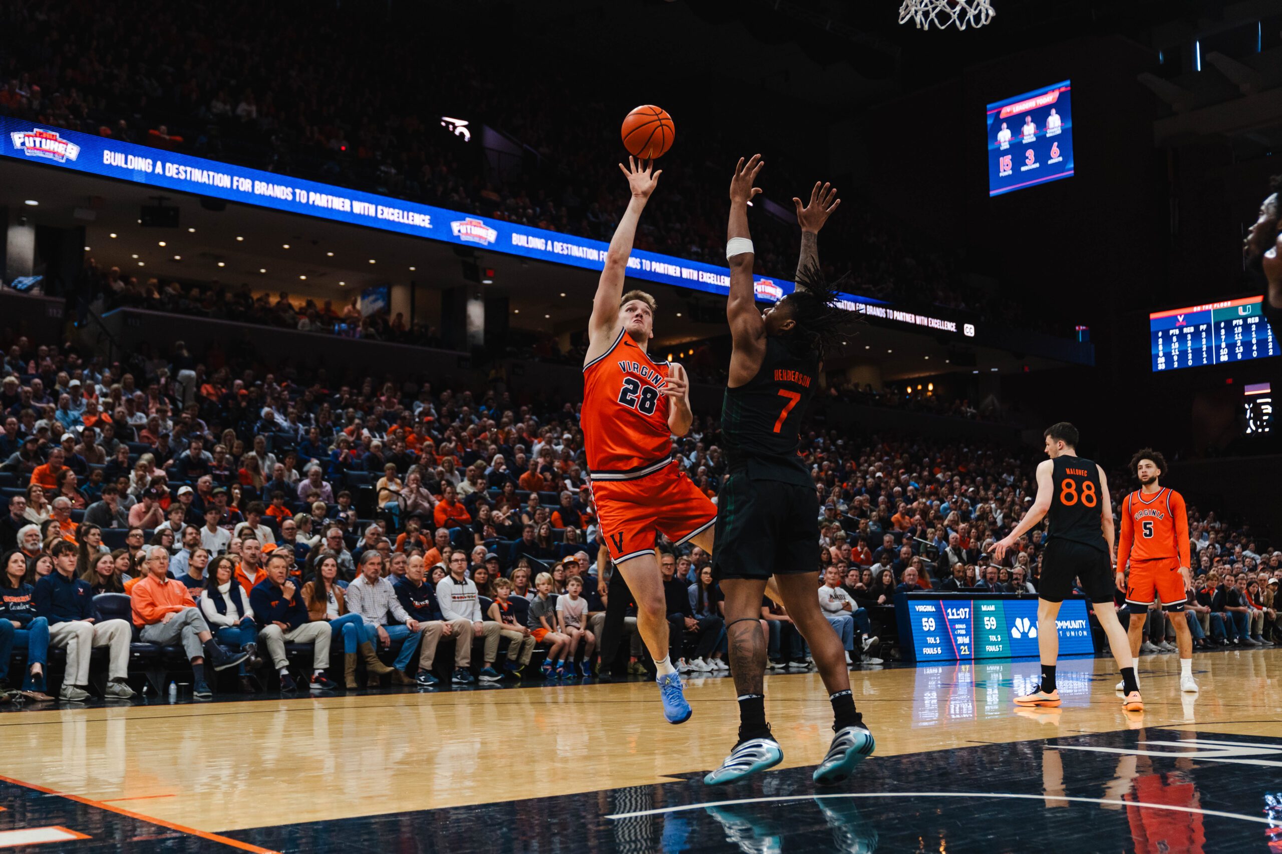 Feb 21, 2026; Charlottesville, Virginia, USA; Virginia Cavaliers forward Thijs de Ridder (28) shoots the ball over Miami (FL) Hurricanes forward Shelton Henderson (7) during the second half at John Paul Jones Arena. Mandatory Credit: Emily Faith Morgan-Imagn Images
