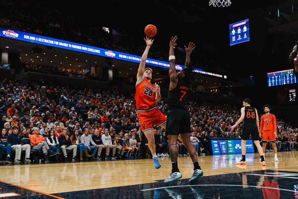 Feb 21, 2026; Charlottesville, Virginia, USA; Virginia Cavaliers forward Thijs de Ridder (28) shoots the ball over Miami (FL) Hurricanes forward Shelton Henderson (7) during the second half at John Paul Jones Arena. Mandatory Credit: Emily Faith Morgan-Imagn Images