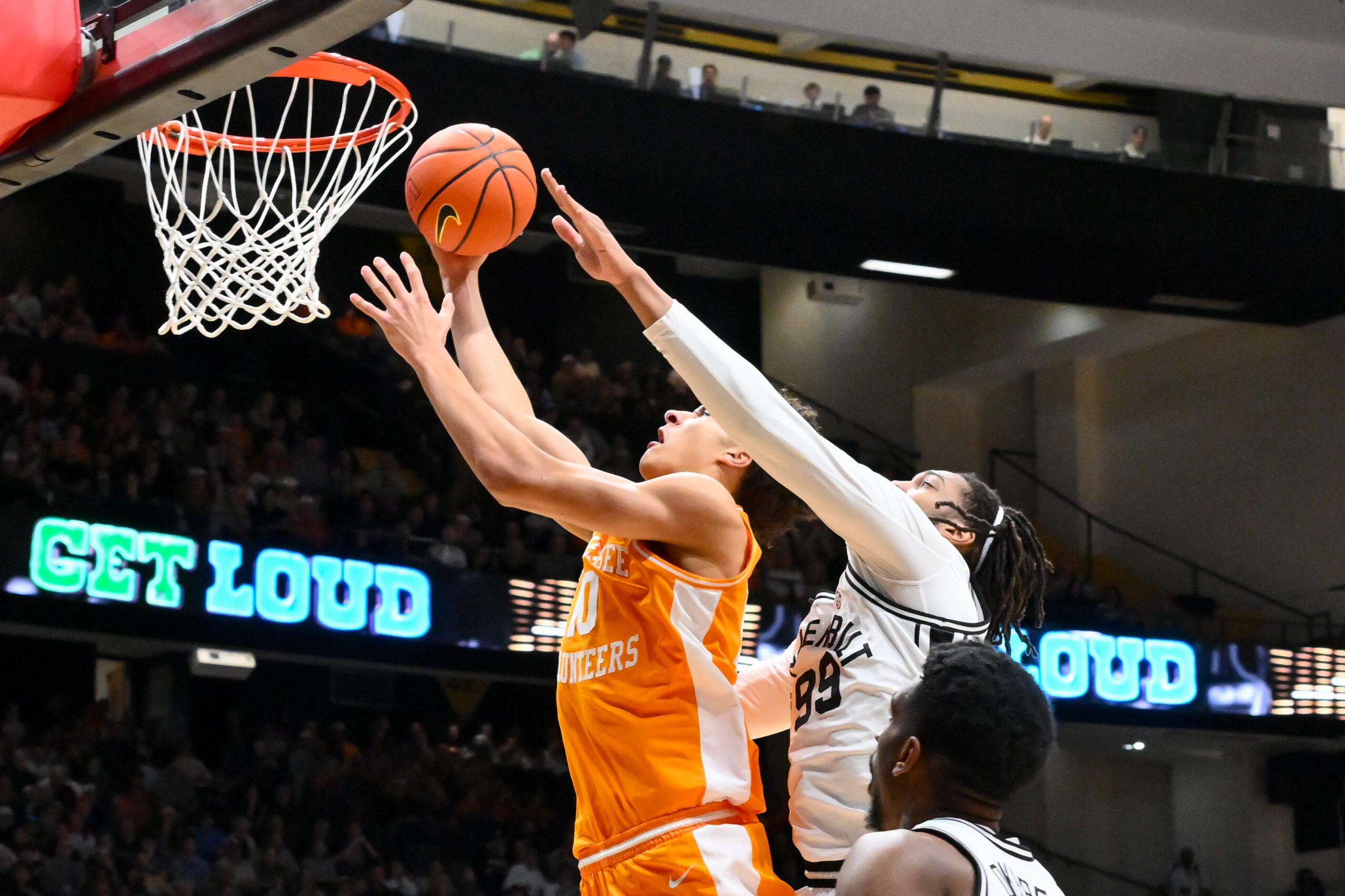 Feb 21, 2026; Nashville, Tennessee, USA;  Tennessee Volunteers forward Nate Ament (10) lays the ball in over Vanderbilt Commodores forward Devin McGlockton (99) during the first half at Memorial Gymnasium. Mandatory Credit: Steve Roberts-Imagn Images
