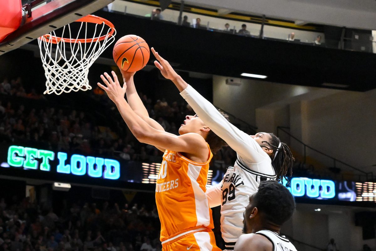 Feb 21, 2026; Nashville, Tennessee, USA; Tennessee Volunteers forward Nate Ament (10) lays the ball in over Vanderbilt Commodores forward Devin McGlockton (99) during the first half at Memorial Gymnasium. Mandatory Credit: Steve Roberts-Imagn Images