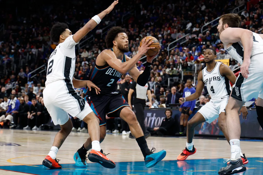 Feb 23, 2026; Detroit, Michigan, USA; Detroit Pistons guard Cade Cunningham (2) dribbles defended by San Antonio Spurs guard Dylan Harper (2) in the second half at Little Caesars Arena. Mandatory Credit: Rick Osentoski-Imagn Images