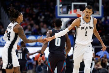 Feb 23, 2026; Detroit, Michigan, USA;  San Antonio Spurs forward Victor Wembanyama (1) receives congratulations from guard Devin Vassell (24) in the second half against the Detroit Pistons at Little Caesars Arena. Mandatory Credit: Rick Osentoski-Imagn Images