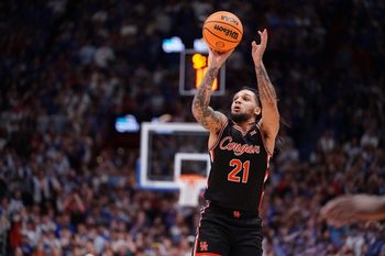 Houston Cougars guard Emanuel Sharp (21) shoots for three against Kansas Jayhawks during the game inside Allen Fieldhouse on Monday, Feb. 23, 2026.