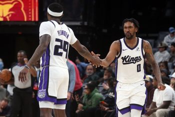 Feb 23, 2026; Memphis, Tennessee, USA; Sacramento Kings guard Malik Monk (0) reacts with guard Daeqwon Plowden (29) during the fourth quarter against the Memphis Grizzlies at FedExForum. Mandatory Credit: Petre Thomas-Imagn Images