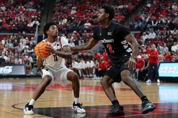 Feb 24, 2026; Lubbock, Texas, USA;  Texas Tech Red Raiders guard Jaylen Petty (11) drives against Cincinnati Bearcats guard Jizzle James (2) in the first half at United Supermarkets Arena. Mandatory Credit: Michael C. Johnson-Imagn Images