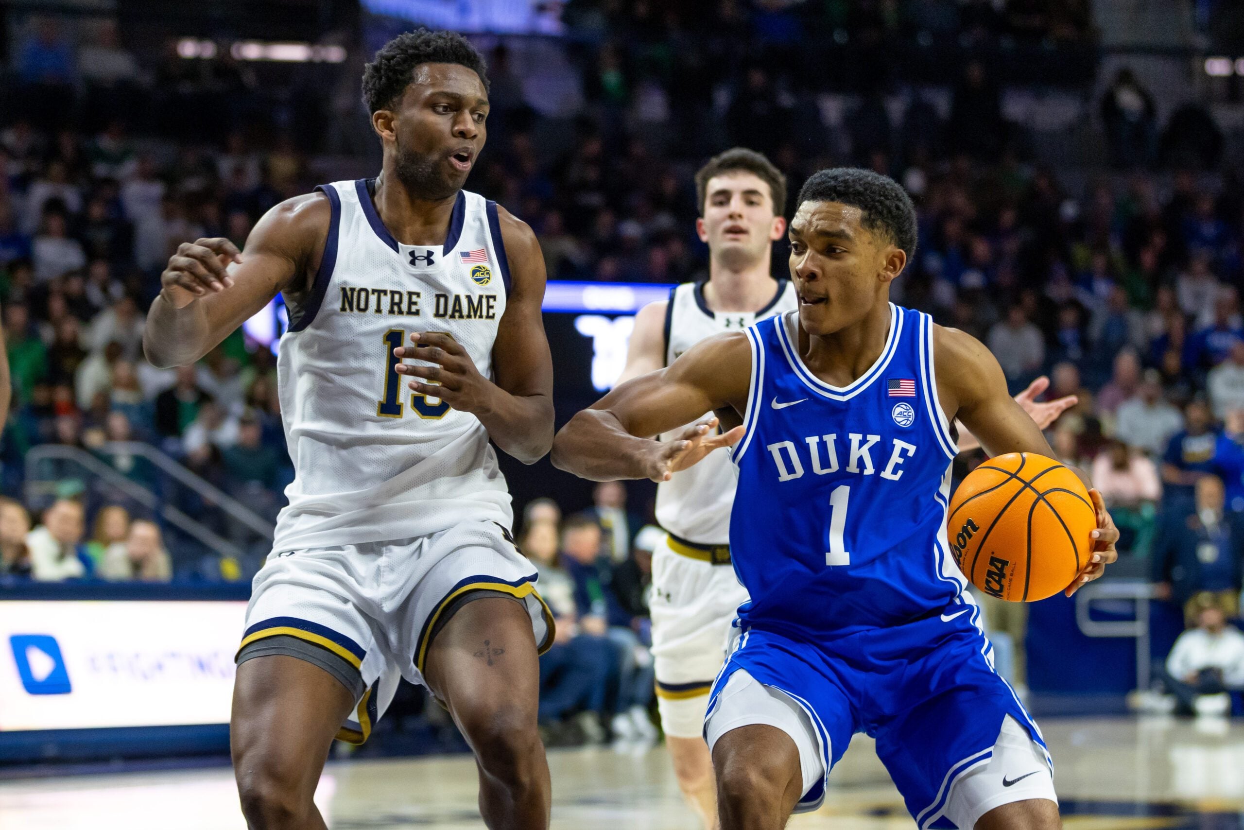 Feb 24, 2026; South Bend, Indiana, USA; Duke Blue Devils guard Caleb Foster (1) drives as Notre Dame Fighting Irish guard Sir Mohammed (13) defends during the second half at Purcell Pavilion at the Joyce Center. Mandatory Credit: Michael Caterina-Imagn Images