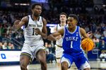 Feb 24, 2026; South Bend, Indiana, USA; Duke Blue Devils guard Caleb Foster (1) drives as Notre Dame Fighting Irish guard Sir Mohammed (13) defends during the second half at Purcell Pavilion at the Joyce Center. Mandatory Credit: Michael Caterina-Imagn Images