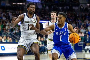 Feb 24, 2026; South Bend, Indiana, USA; Duke Blue Devils guard Caleb Foster (1) drives as Notre Dame Fighting Irish guard Sir Mohammed (13) defends during the second half at Purcell Pavilion at the Joyce Center. Mandatory Credit: Michael Caterina-Imagn Images