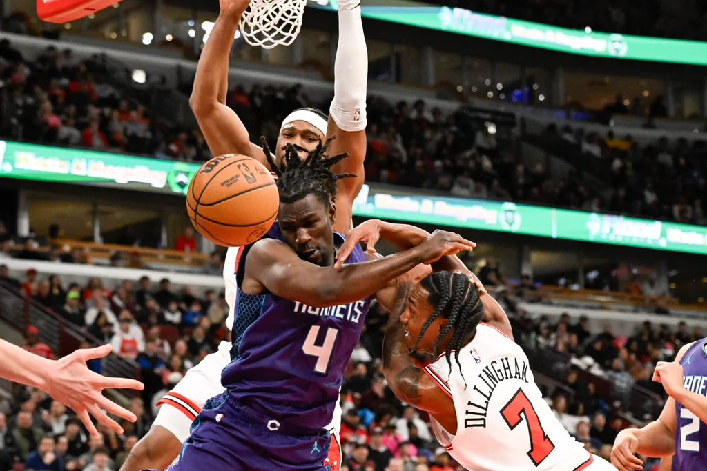Feb 24, 2026; Chicago, Illinois, USA; Charlotte Hornets guard Sion James (4) fights for the ball against Chicago Bulls forward Guerschon Yabusele (28) and guard Rob Dillingham (7) during the second half at United Center. Mandatory Credit: Matt Marton-Imagn Images