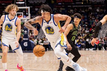 Feb 24, 2026; New Orleans, Louisiana, USA;  Golden State Warriors forward Gui Santos (15) dribbles against New Orleans Pelicans guard Jeremiah Fears (0) during the second half at Smoothie King Center. Mandatory Credit: Stephen Lew-Imagn Images