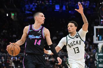 Feb 24, 2026; Milwaukee, Wisconsin, USA;  Miami Heat guard Tyler Herro (14) looks for a shot against Milwaukee Bucks guard Ryan Rollins (13) in the fourth quarter at Fiserv Forum. Mandatory Credit: Benny Sieu-Imagn Images