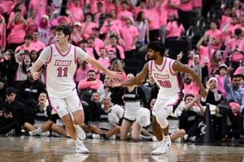 Feb 25, 2026; Providence, Rhode Island, USA; Providence Friars guard Nilavan Daniels (20) celebrates a basket against the Xavier Musketeers with guard Ryan Mela (11) during the second half at Amica Mutual Pavilion. Mandatory Credit: Eric Canha-Imagn Images