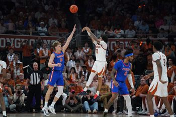Feb 25, 2026; Austin, Texas, USA; Texas Longhorns guard Jordan Pope (0) shoots a three point basket against Florida Gators forward Thomas Haugh (10) during the second half at Moody Center. Mandatory Credit: Dustin Safranek-Imagn Images