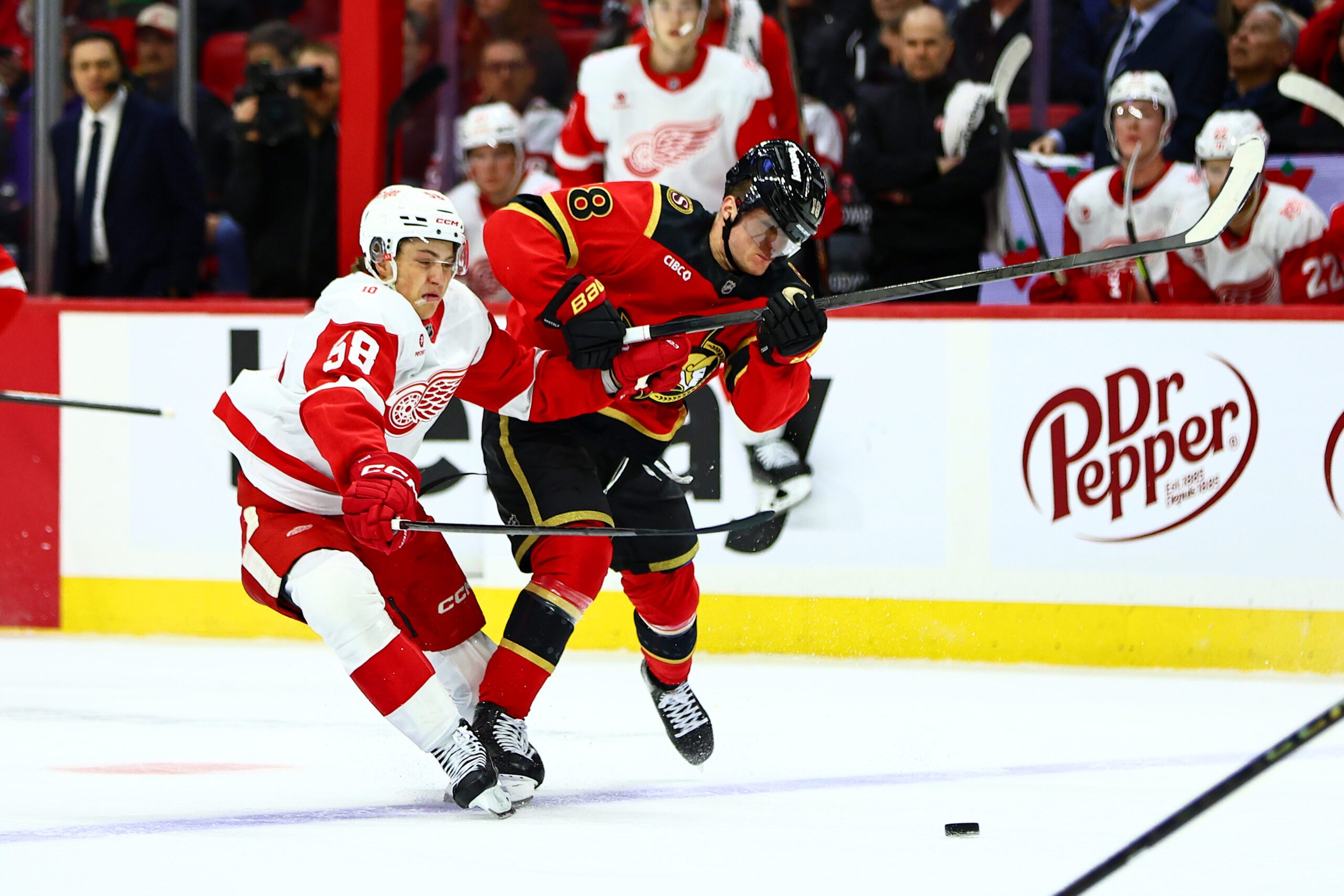 Feb 26, 2026; Ottawa, Ontario, CAN; Detroit Red Wings center Emmitt Finnie (58) and Ottawa Senators center Tim Stutzle (18) collide as they vie for the puck during the second period at Canadian Tire Centre. Mandatory Credit: Keito Newman-Imagn Images