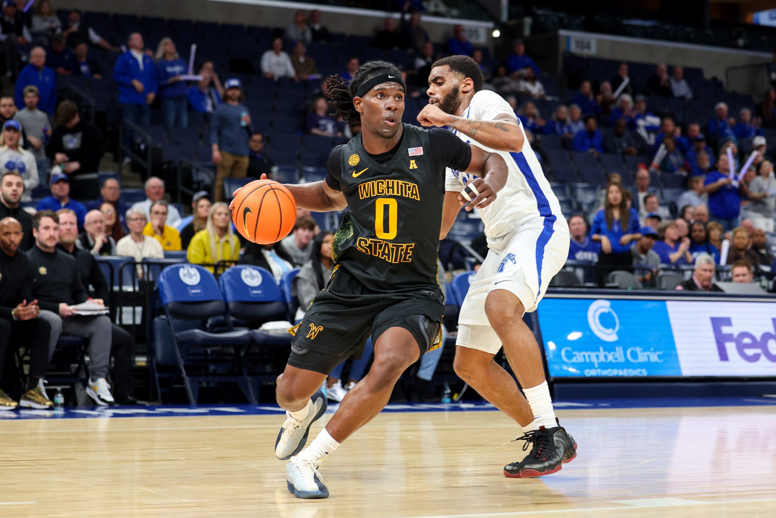 Feb 26, 2026; Memphis, Tennessee, USA; Wichita State Shockers forward Karon Boyd (0) drives to the basket against Memphis Tigers guard Sincere Parker (23) during the second half at FedExForum. Mandatory Credit: Wesley Hale-Imagn Images
