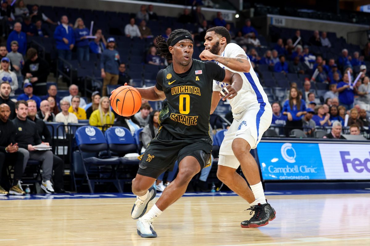Feb 26, 2026; Memphis, Tennessee, USA; Wichita State Shockers forward Karon Boyd (0) drives to the basket against Memphis Tigers guard Sincere Parker (23) during the second half at FedExForum. Mandatory Credit: Wesley Hale-Imagn Images