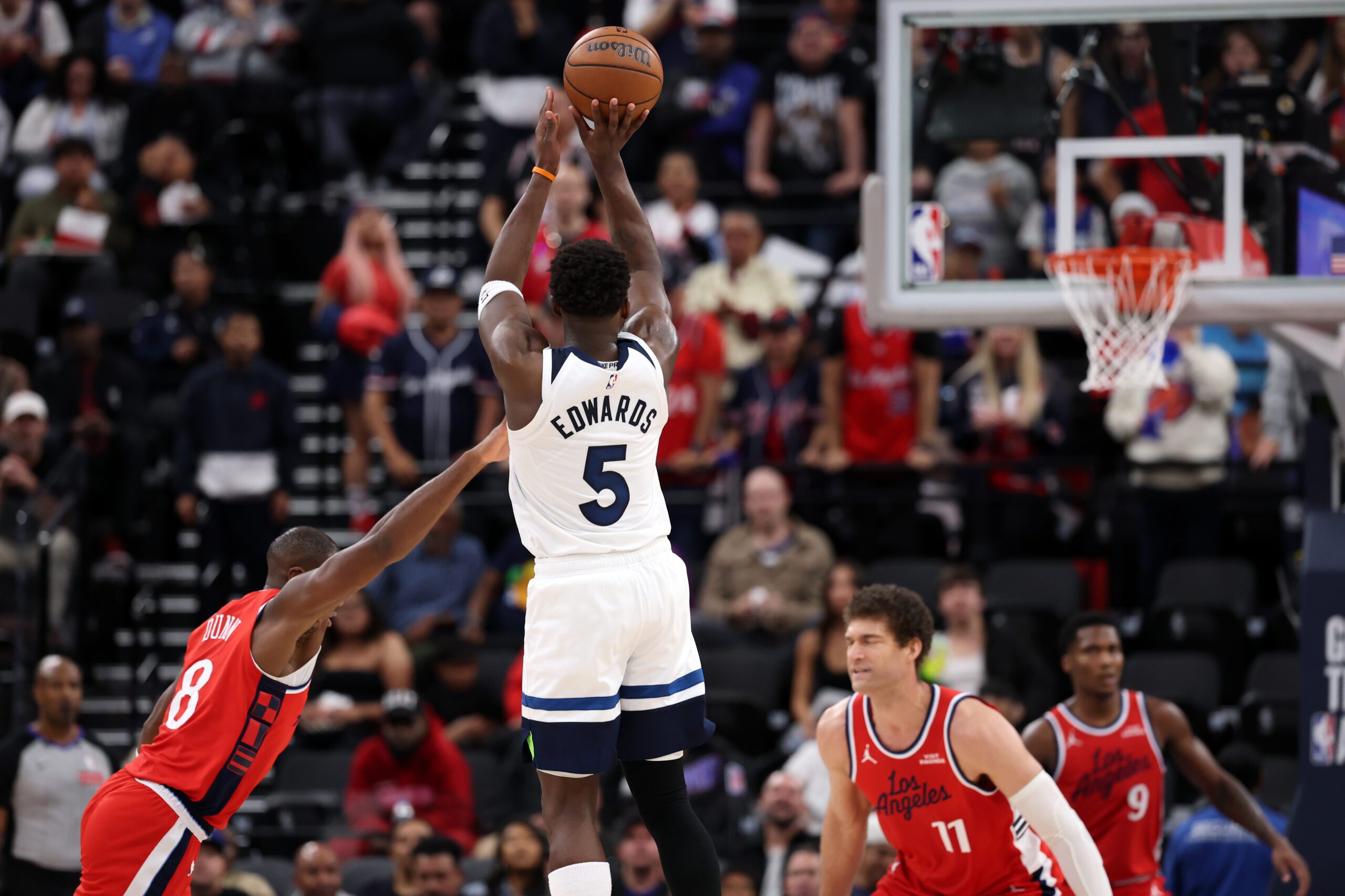 Feb 26, 2026; Inglewood, California, USA;   Minnesota Timberwolves guard Anthony Edwards (5) shoots the ball over Los Angeles Clippers guard Kris Dunn (8) during the second half at Intuit Dome. Mandatory Credit: Kiyoshi Mio-Imagn Images