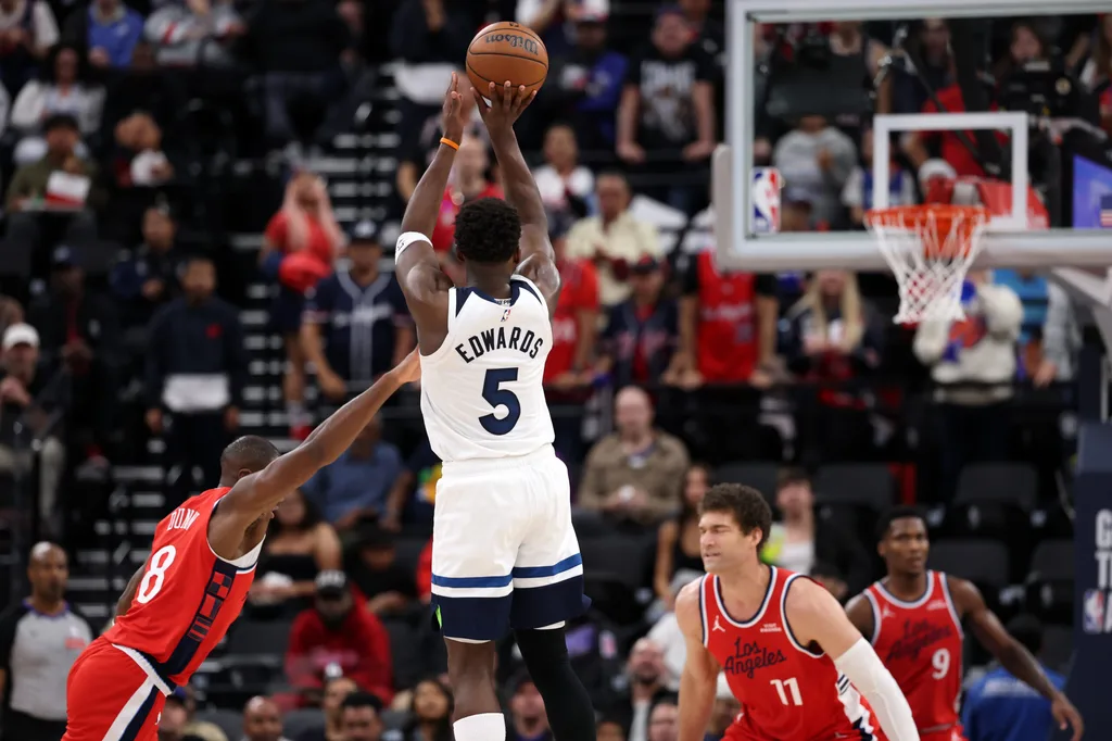 Feb 26, 2026; Inglewood, California, USA; Minnesota Timberwolves guard Anthony Edwards (5) shoots the ball over Los Angeles Clippers guard Kris Dunn (8) during the second half at Intuit Dome. Mandatory Credit: Kiyoshi Mio-Imagn Images