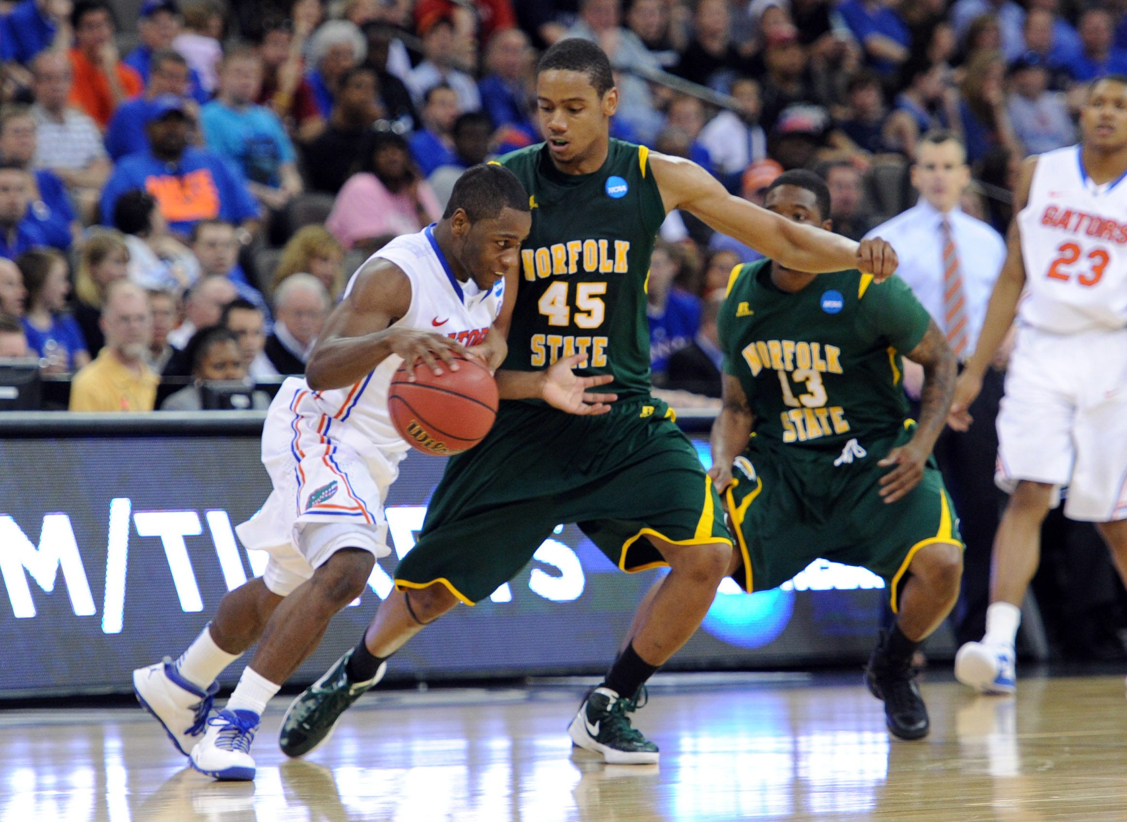 Mar 18, 2012; Omaha, NE, USA; Florida Gators guard Erving Walker (11) drives against Norfolk State Spartans forward A.J. Rogers (45) during the second half in the third round of the 2012 NCAA men's basketball tournament at the CenturyLink Center. Florida defeated Norfolk State 84-50. Mandatory Credit: Peter G. Aiken-Imagn Images