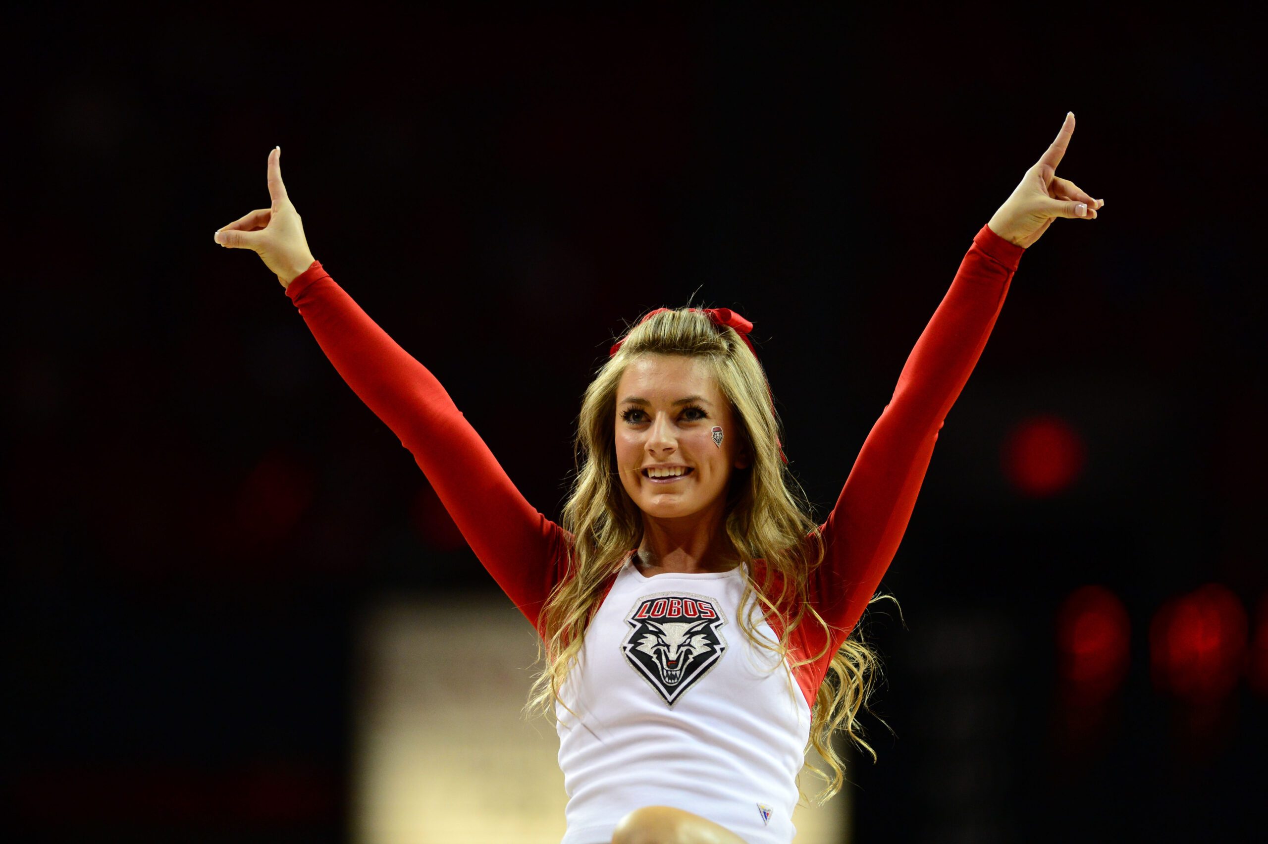 Mar 15, 2013; Las Vegas, NV, USA; New Mexico Lobos cheerleader performs during a timeout in the first half of the game against the San Diego State Aztecs during the semifinals of the Mountain West tournament at the Thomas & Mack Center. Mandatory Credit: Ron Chenoy-Imagn Images