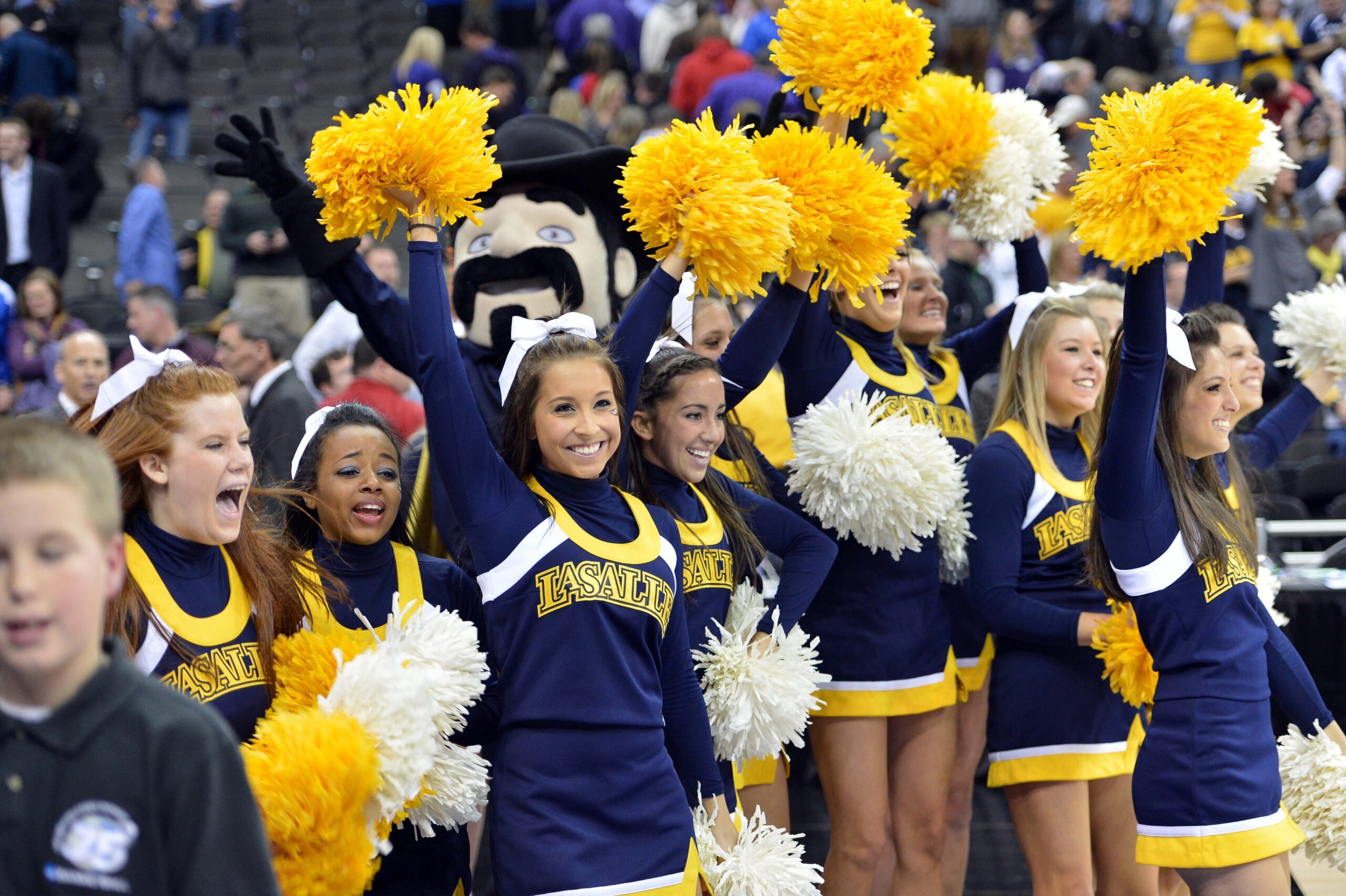 Mar 22, 2013; Kansas City, MO, USA; La Salle Explorers cheerleaders celebrate after beating the Kansas State Wildcats 63-61 during the second round of the 2013 NCAA tournament at the Sprint Center. Mandatory Credit: Peter G. Aiken-Imagn Images