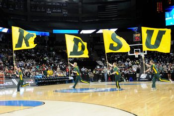 Mar 22, 2014; Spokane, WA, USA; North Dakota State Bison cheerleaders run across court with flags before a men's college basketball game during the third round of the 2014 NCAA Tournament against the San Diego State Aztecs at Veterans Memorial Arena. Mandatory Credit: James Snook-Imagn Images