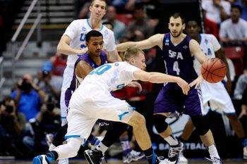 Mar 23, 2014; San Diego, CA, USA; UCLA Bruins guard Bryce Alford (20) passes the ball away from Stephen F. Austin Lumberjacks guard Trey Pinkney in the second half of a men's college basketball game during the third round of the 2014 NCAA Tournament at Viejas Arena. Mandatory Credit: Robert Hanashiro-Imagn Images