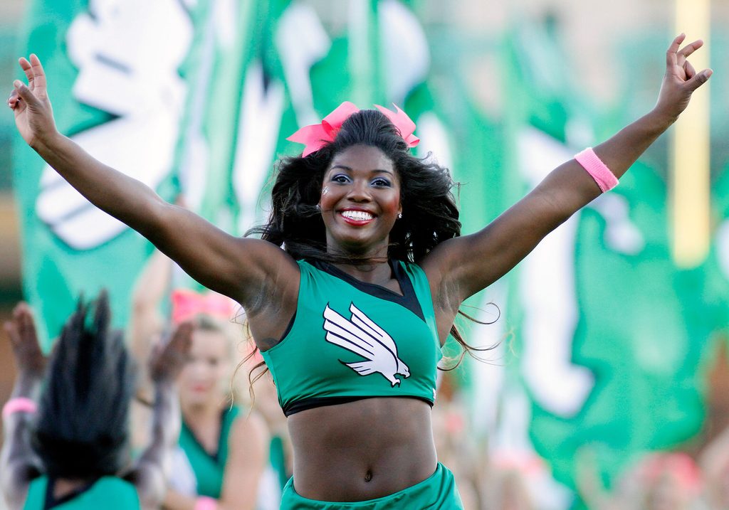 Oct 18, 2014; Denton, TX, USA; North Texas Mean Green cheerleader runs onto the field prior to the game vs Southern Miss Golden Eagles at Apogee Stadium. Southern Miss won 30-20. Mandatory Credit: Ray Carlin-Imagn Images